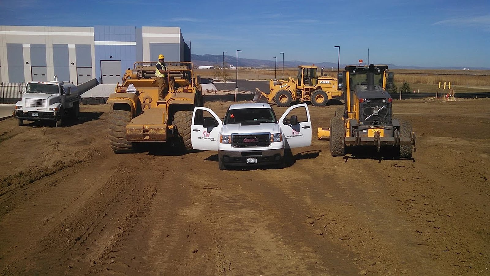 Caterpillar motor grader shaping an Arizona commercial site