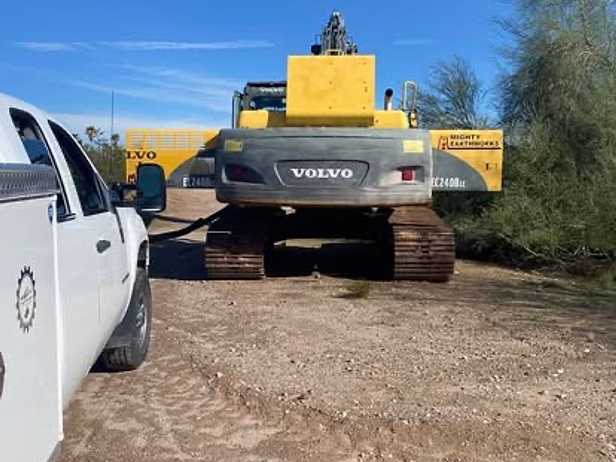 Mighty Earthworks Volvo excavator staged on an Arizona jobsite