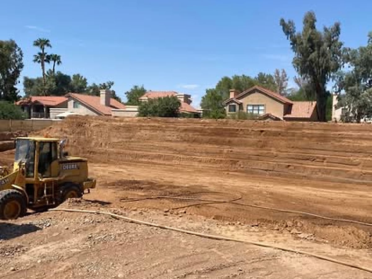 Wide graded commercial building pad prepared under a clear sky